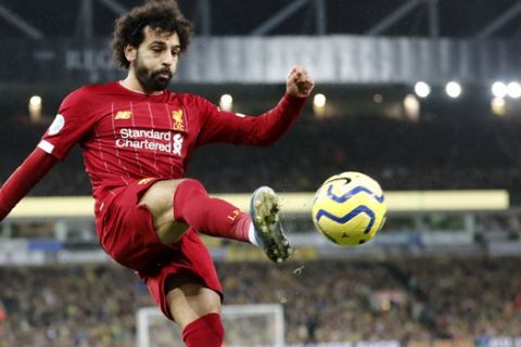 Liverpool's Mohamed Salah kicks the ball during the English Premier League soccer match between Norwich City and Liverpool at Carrow Road Stadium in Norwich, England, Saturday, Feb. 15, 2020. (AP Photo/Frank Augstein)
