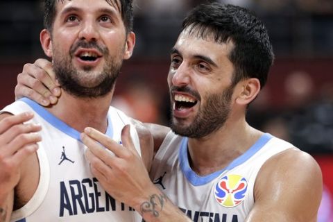 Nicolas Laprovittola, left, and Facundo Campazzo of Argentina celebrate after beating France in their semifinal match against in the FIBA Basketball World Cup at the Cadillac Arena in Beijing, Friday, Sept. 13, 2019. (AP Photo/Mark Schiefelbein)