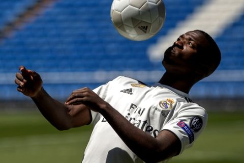 Brazilian new Real Madrid soccer player Vinicius Jr plays the ball for the media during his official presentation for Real Madrid at the Santiago Bernabeu stadium in Madrid, Spain, Friday, July 20, 2018. (AP Photo/Francisco Seco)