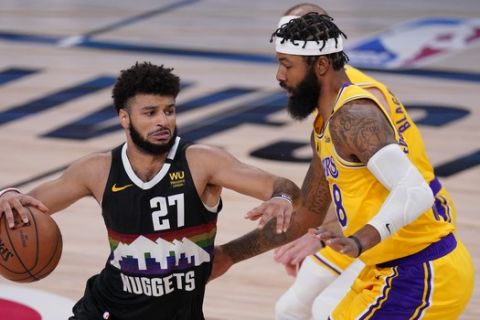 Denver Nuggets' Jamal Murray (27) drives against Los Angeles Lakers' Markieff Morris during the second half of an NBA conference final playoff basketball game Thursday, Sept. 24, 2020, in Lake Buena Vista, Fla. The Lakers won 114-108. (AP Photo/Mark J. Terrill)