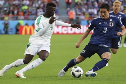 Senegal's Mbaye Niang, left, and Japan's Gen Shoji challenge for the ball during the group H match between Japan and Senegal at the 2018 soccer World Cup at the Yekaterinburg Arena in Yekaterinburg , Russia, Sunday, June 24, 2018. (AP Photo/Eugene Hoshiko)