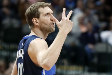 Dallas Mavericks forward Dirk Nowitzki celebrates sinking a 3-point basket during the second half of the team's NBA basketball game against the Indiana Pacers in Dallas, Wednesday, Feb. 27, 2019. (AP Photo/Tony Gutierrez)