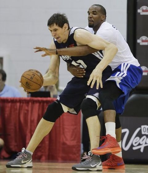 Atlanta Hawks Boban Marjanovic, left, is fouled by Los Angeles Clippers Samardo Samuels in the fourth quarter of an NBA Summer League game, Friday, July 12, 2013, in Las Vegas. (AP Photo/Julie Jacobson) 