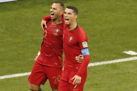 Portugal's Ricardo Quaresma, left, celebrates with his teammate Cristiano Ronaldo after scoring his side's first goal during the group B match between Iran and Portugal at the 2018 soccer World Cup at the Mordovia Arena in Saransk, Russia, Monday, June 25, 2018. (AP Photo/Darko Bandic)