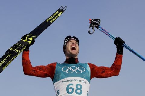 Dario Cologna, of Switzerland, celebrates after winning the the gold medal in the men's 15km freestyle cross-country skiing competition at the 2018 Winter Olympics in Pyeongchang, South Korea, Friday, Feb. 16, 2018. (AP Photo/Kirsty Wigglesworth)