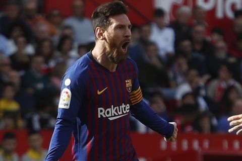 Barcelona forward Lionel Messi celebrates after scoring his side's the goal during La Liga soccer match between Sevilla and Barcelona at the Ramon Sanchez Pizjuan stadium in Seville, Spain. Saturday, February 23, 2019. (AP Photo/Miguel Morenatti)