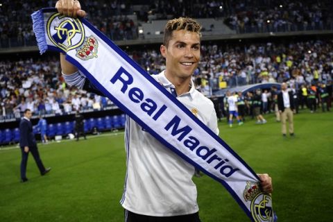 Real Madrid's Cristiano Ronaldo celebrates after winning a Spanish La Liga soccer match between Malaga and Real Madrid in Malaga, Spain, Sunday, May 21, 2017. Real Madrid wins the Spanish league for the first time in five years, avoiding its biggest title drought since the 1980s. (AP Photo/Daniel Tejedor)