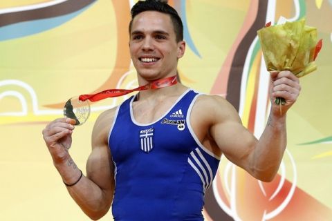 epa04710493 Greek gymnast Eleftherios Petrounias  holds his gold medal after winning the Men's rings final at the Men's European Artistic Gymnastic Championships in Montpellier, France, 18 April 2015.  EPA/GUILLAUME HORCAJUELO
