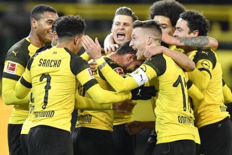 Dortmund's captain Marco Reus, 3rd from right, celebrates with his team the opening goal by Paco Alcacer, center, during the German Bundesliga soccer match between Borussia Dortmund and Werder Bremen in Dortmund, Germany, Saturday, Dec. 15, 2018. (AP Photo/Martin Meissner)