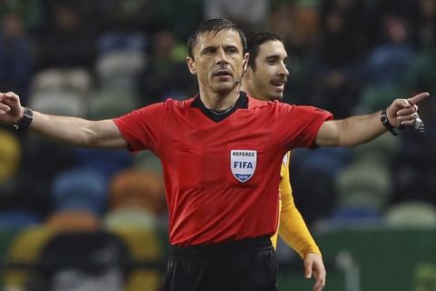 FILE - In this Thursday, April 12, 2018 file photo, referee Milorad Mazic gestures during the Europa League quarterfinal second leg soccer match between Sporting CP and Atletico Madrid at the Alvalade stadium in Lisbon. UEFA has picked two World Cup referees for its club competition finals before the tournament in Russia. UEFA says Milorad Mazic of Serbia will referee the Champions League final between Liverpool and Real Madrid on May 26 in Kiev. Bjorn Kuipers of the Netherlands will referee the Atletico Madrid-Marseille Europa League final May 16 in Lyon. (AP Photo/Armando Franca, File)