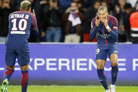 Paris Saint Germain's Kylian Mbappe, right, reacts with Neymar after he scored the second goal against Lyon during their French League One soccer match between PSG and Olympique Lyon at the Parc des Princes stadium in Paris, France, Sunday, Sept. 17, 2016. (AP Photo/Francois Mori)