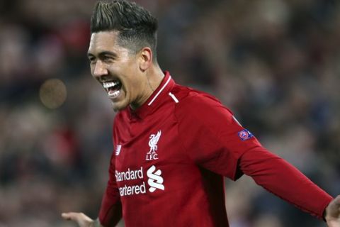 Liverpool's Roberto Firmino celebrates after scoring his side's second goal during the Champions League quarterfinal, first leg, soccer match between Liverpool and FC Porto at Anfield Stadium, Liverpool, England, Tuesday April 9, 2019. (AP Photo/Dave Thompson)