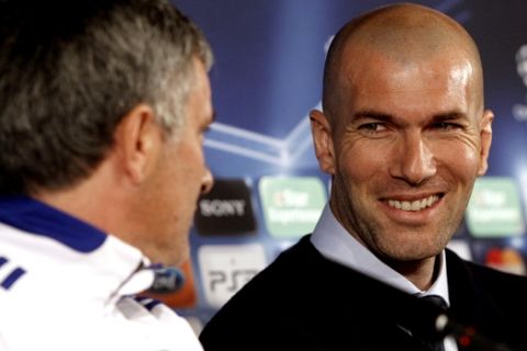 Special adviser to Real Madrid's first team Zinedine Zidane, right, and Real Madrid's coach Jose Mourinho, left, laugh during a press conference in Lyon, central France, Monday, Feb. 21, 2011. Real Madrid will face Lyon in a Champions League soccer match on Tuesday. (AP Photo/Laurent Cipriani)