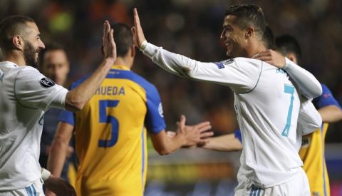 Real Madrid's Cristiano Ronaldo, right, celebrates after scoring the sixth goal of his team with Karim Benzema during the Champions League Group H soccer match between APOEL Nicosia and Real Madrid at GSP stadium, in Nicosia, on Tuesday, Nov. 21, 2017. (AP Photo/Petros Karadjias)