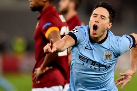 Manchester City's French midfielder Samir Nasri celebrates after scoring during the UEFA Champions League football match AS Roma vs Manchester City on December 10, 2014 at the Olympic stadium in Rome.      AFP PHOTO / GABRIEL BOUYS        (Photo credit should read GABRIEL BOUYS/AFP/Getty Images)