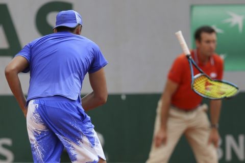Australia's Nick Kyrgios breaks his racket in his second round match against South Africa's Kevin Anderson at the French Open tennis tournament at the Roland Garros stadium, in Paris, France. Thursday, June 1, 2017. (AP Photo/David Vincent)