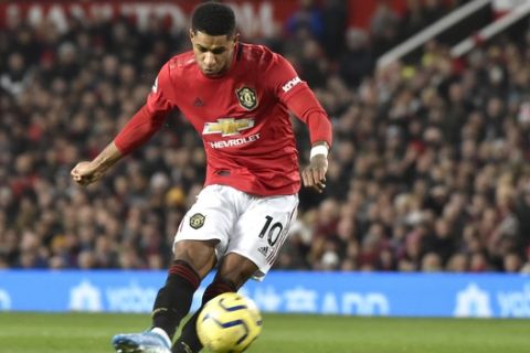 Manchester United's Marcus Rashford kicks the ball during the English Premier League soccer match between Manchester United and Tottenham Hotspur at Old Trafford in Manchester, England, Wednesday, Dec. 4, 2019. (AP Photo/Rui Vieira)