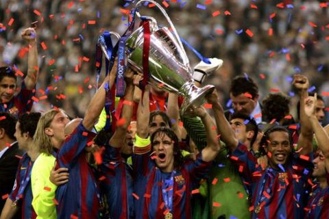 Barcelona players celebrate with the trophy after they won the UEFA Champions League against Arsenal in the Stade de France in Saint-Denis, outside Paris, Wednesday, May 17, 2006. (AP Photo/Matt Dunham)