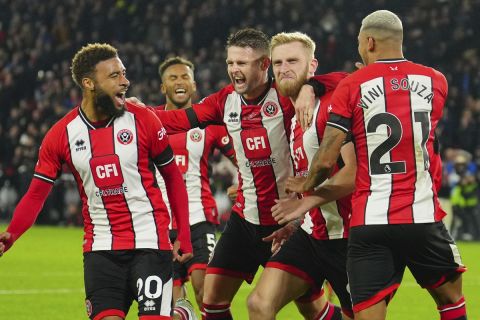 Sheffield United's players celebrate after Sheffield United's Oli McBurnie, second right, scored his side's opening goal during the English Premier League soccer match between Sheffield United and Manchester United at Bramall Lane in Sheffield, England, Saturday, Oct. 21, 2023. (AP Photo/Jon Super)
