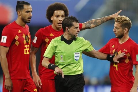Belgium's Nacer Chadli, left, Belgium's Axel Witsel, center, and Belgium's Dries Mertens, right, argue to referee Andres Cunha during the semifinal match between France and Belgium at the 2018 soccer World Cup in the St. Petersburg Stadium in, St. Petersburg, Russia, Tuesday, July 10, 2018. (AP Photo/Frank Augstein)