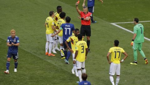 Referee Damir Skomina from Slovenia shows a red card to Colombia's Carlos Sanchez during the group H match between Colombia and Japan at the 2018 soccer World Cup in the Mordavia Arena in Saransk, Russia, Tuesday, June 19, 2018. (AP Photo/Vadim Ghirda)