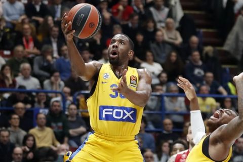 Maccabi Fox Tel Aviv's Norris Cole, top, goes for the basket during the Euro League basketball match between Olimpia Milan and Maccabi Fox Tel Aviv, in Milan, Italy, Friday, Jan. 26, 2018. (AP Photo/Antonio Calanni)