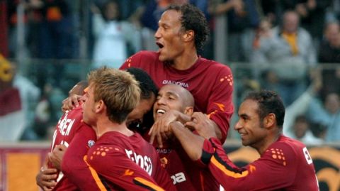 Roma's John Carew, left, of Norway, is congratulated by his teammates Johnatan Zebina, top, of France, Emerson, right, of Brazil, Olivier Dacourt, center, of France, and Daniele De Rossi, second from left, after he scored during the Italian Serie A top league soccer match between Roma and Reggina in Rome's Olympic stadium, Sunday, Nov. 2, 2003. (AP Photo/Giuseppe Calzuola)