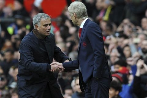 Manchester United manager Jose Mourinho, left, shakes hands with Arsenal manager Arsene Wenger at the end of the English Premier League soccer match between Manchester United and Arsenal at the Old Trafford stadium in Manchester, England, Sunday, April 29, 2018. (AP Photo/Rui Vieira)