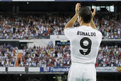 Real Madrid new soccer player Cristiano Ronaldo from Portugal gestures to fans during his presentation at the Santiago Bernabeu stadium in Madrid on Monday, July 6, 2009. (AP Photo/Victor R. Caivano)