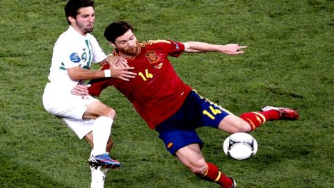 Spains Xabi Alonso, right and Portugals Joao Moutinho fight for the ball during the Euro 2012 soccer championship semifinal match between Spain and Portugal in Donetsk, Ukraine, Wednesday, June 27, 2012. (AP Photo/Darko Vojinovic)