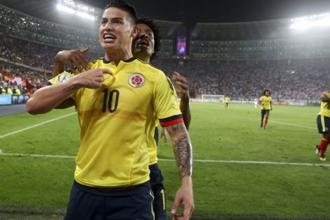 Colombia's James Rodriguez celebrates after scoring against Peru during a 2018 World Cup qualifying soccer match in Lima, Peru, Tuesday, Oct. 10, 2017. Behind Rodriguez is Colombia's Juan Cuadrado. (AP Photo/Martin Mejia)