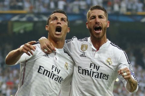 Real Madrid's Cristiano Ronaldo and teammate Sergio Ramos, right, celebrate after Ronaldo scored 1-0 during the Champions League second leg semifinal soccer match between Real Madrid and Juventus, at the Santiago Bernabeu stadium in Madrid, Wednesday, May 13, 2015. (AP Photo/Daniel Ochoa de Olza)