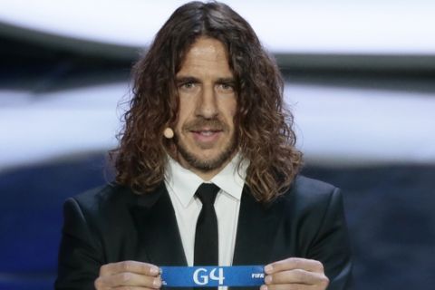Former Spanish soccer international Carles Puyol holds a lot at the 2018 soccer World Cup draw in the Kremlin in Moscow, Friday, Dec. 1, 2017. (AP Photo/Ivan Sekretarev)