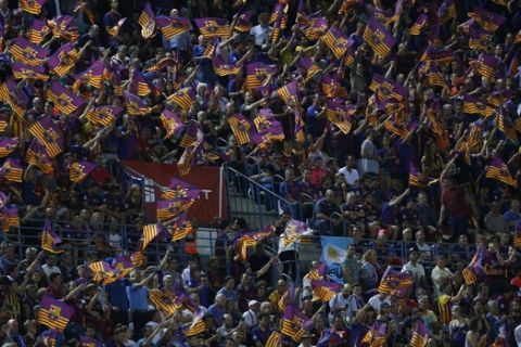 Barcelona fans wave flags at the end of the Copa del Rey final soccer match between Barcelona and Alaves at the Vicente Calderon stadium in Madrid, Spain, Saturday, May 27, 2017. Barcelona won the cup final 3-1. (AP Photo/Francisco Seco)