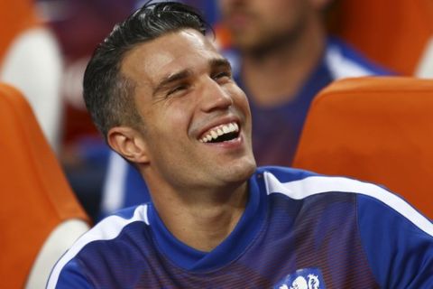 Substitute player Netherlands' Robin van Persie laughs as he waits for the start of the Euro 2016 qualifying soccer match between Netherlands and Iceland, at the ArenA stadium, in Amsterdam, Netherlands, Thursday, Sept. 3, 2015. Iceland won the match with a 1-0 score. (AP Photo/Peter Dejong)