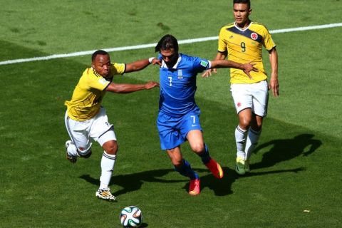 BELO HORIZONTE, BRAZIL - JUNE 14: Giorgos Samaras of Greece is challenged by Juan Camilo Zuniga of Colombia during the 2014 FIFA World Cup Brazil Group C match between Colombia and Greece at Estadio Mineirao on June 14, 2014 in Belo Horizonte, Brazil.  (Photo by Ian Walton/Getty Images)