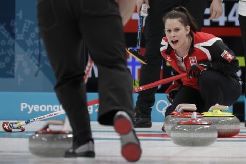 Switzerland Jenny Perret gives instructions to her teammate Martin Rios during their mixed doubles curling match against Norway at the 2018 Winter Olympics in Gangneung, South Korea, Friday, Feb. 9, 2018. (AP Photo/Aaron Favila)