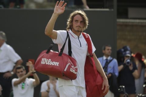 Stefanos Tsitsipas of Greece leaves the court after being defeated by John Isner of the US in their men's singles match on the seventh day at the Wimbledon Tennis Championships in London, Monday July 9, 2018. (AP Photo/Ben Curtis)