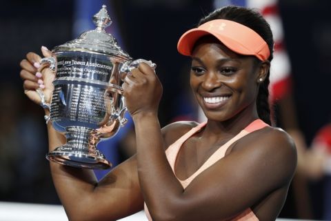 Sloane Stephens, of the United States, holds up the championship trophy after beating Madison Keys, of the United States, in the women's singles final of the U.S. Open tennis tournament, Saturday, Sept. 9, 2017, in New York. (AP Photo/Adam Hunger)
