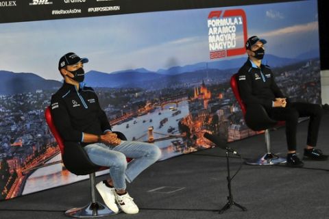 Williams drivers George Russell of Britain, left and Williams driver Nicholas Latifi of Canada attend drivers news conference at the Hungaroring racetrack in Mogyorod, Hungary, Thursday, July 16, 2020. The Hungarian Formula One Grand Prix race will take place on Sunday. (FIA Pool via AP)