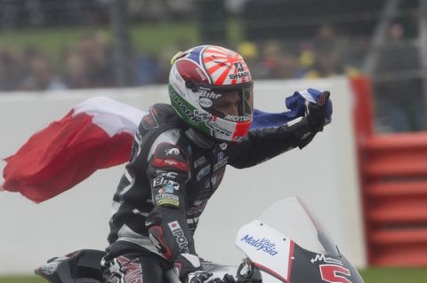 NORTHAMPTON, ENGLAND - AUGUST 30:  Johann Zarco of French and AJO Motorsport celebrates the victory with flag at the end of the Moto2 race during the MotoGp Of Great Britain - Race at Silverstone Circuit on August 30, 2015 in Northampton, United Kingdom.  (Photo by Mirco Lazzari gp/Getty Images)
