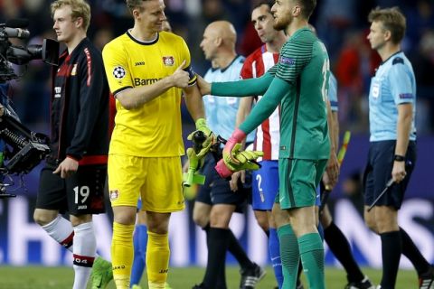 Leverkusen goalkeeper Bernd Leno, left, lifts a thumb as he says good bye to Atletico goalkeeper Jan Oblak, right, after the Champions League round of 16 second leg soccer match between Atletico Madrid and Bayer 04 Leverkusen in Madrid, Spain, Wednesday, March 15, 2017. The match ended in a 0-0 draw. (AP Photo/Francisco Seco)