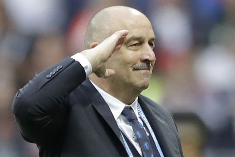 Russia head coach Stanislav Cherchesov, left, salutes to goal scorer Russia's Artyom Dzyuba during the group A match between Russia and Saudi Arabia which opens the 2018 soccer World Cup at the Luzhniki stadium in Moscow, Russia, Thursday, June 14, 2018. (AP Photo/Matthias Schrader)