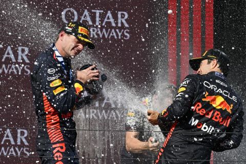 Dutch Formula One driver Max Verstappen of Red Bull Racing, left, sprays champagne with third placed Mexican Formula One driver Sergio Perez of Red Bull Racing after winning the Formula One Hungarian Grand Prix auto race, at the Hungaroring racetrack in Mogyorod, near Budapest, Hungary, Sunday, July 23, 2023. (AP Photo/Denes Erdos)