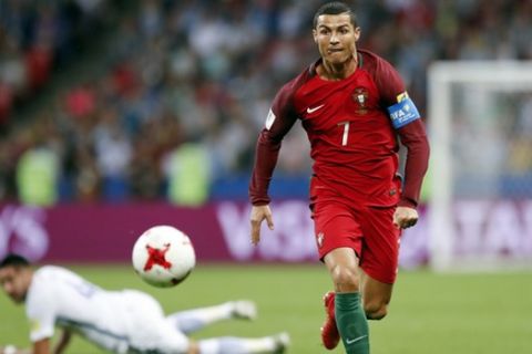 FILE - In this Wednesday, June 28, 2017 filer, Portugal's Cristiano Ronaldo keeps his eyes on the ball during the Confederations Cup, semifinal soccer match between Portugal and Chile, at the Kazan Arena, Russia. (AP Photo/Pavel Golovkin, File)