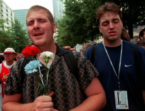Kenneth Smith, of Glendale, Ore., left, and and an unidentified man  visit the Centennial Olympic Park as it was reopened Tuesday, July 30, 1996 since the fatal bombing on Saturday. Thousands flocked to Centennial Olympic Park Tuesday, reclaiming the festive heart of the Summer Games   even as the FBI pressed ahead with its hunt for the terrorist who bombed it. (AP Photo/Kathy Willens)