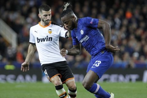 Chelsea's Michy Batshuayi, right, and Valencia's Jose Luis Gaya challenge for the ball during the Champions League group H soccer match between Valencia and Chelsea at the Mestalla stadium in Valencia, Spain, Wednesday, Nov. 27, 2019. (AP Photo/Alberto Saiz)