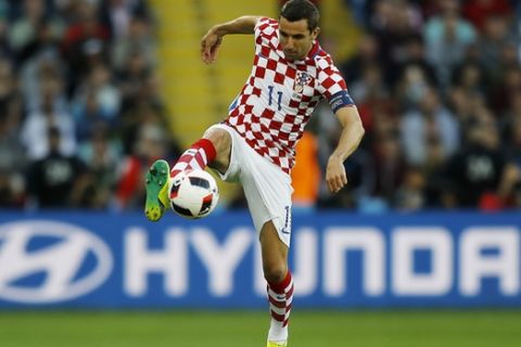 Croatia's Darijo Srna goes for the ball during the Euro 2016 round of 16 soccer match between Croatia and Portugal at the Bollaert stadium in Lens, France, Saturday, June 25, 2016. (AP Photo/Frank Augstein)