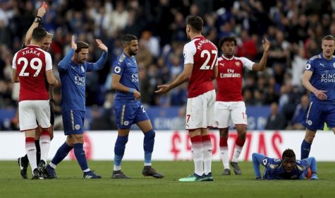 Arsenal's Konstantinos Mavropanos, no. 27, is sent off by match referee Graham Scott during the English Premier League soccer match against Leicester City at the King Power Stadium, Leicester, England, Wednesday May 9, 2018. (David Davies/PA via AP)
