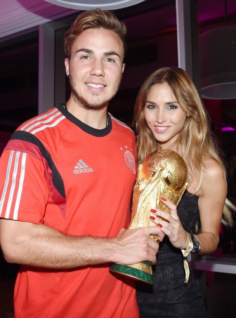 RIO DE JANEIRO, BRAZIL - JULY 13:  Goalscorer Mario Gotze of Germany and girlfriend Ann-Kathrin Brommel pose with the World Cup trophy as he celebrates with teammates at a party, after winning the 2014 FIFA World Cup Brazil Final match against Argentina, at Sheraton Hotel on July 13, 2014 in Rio de Janeiro, Brazil.  (Photo by Markus Gilliar - Pool/Getty Images)